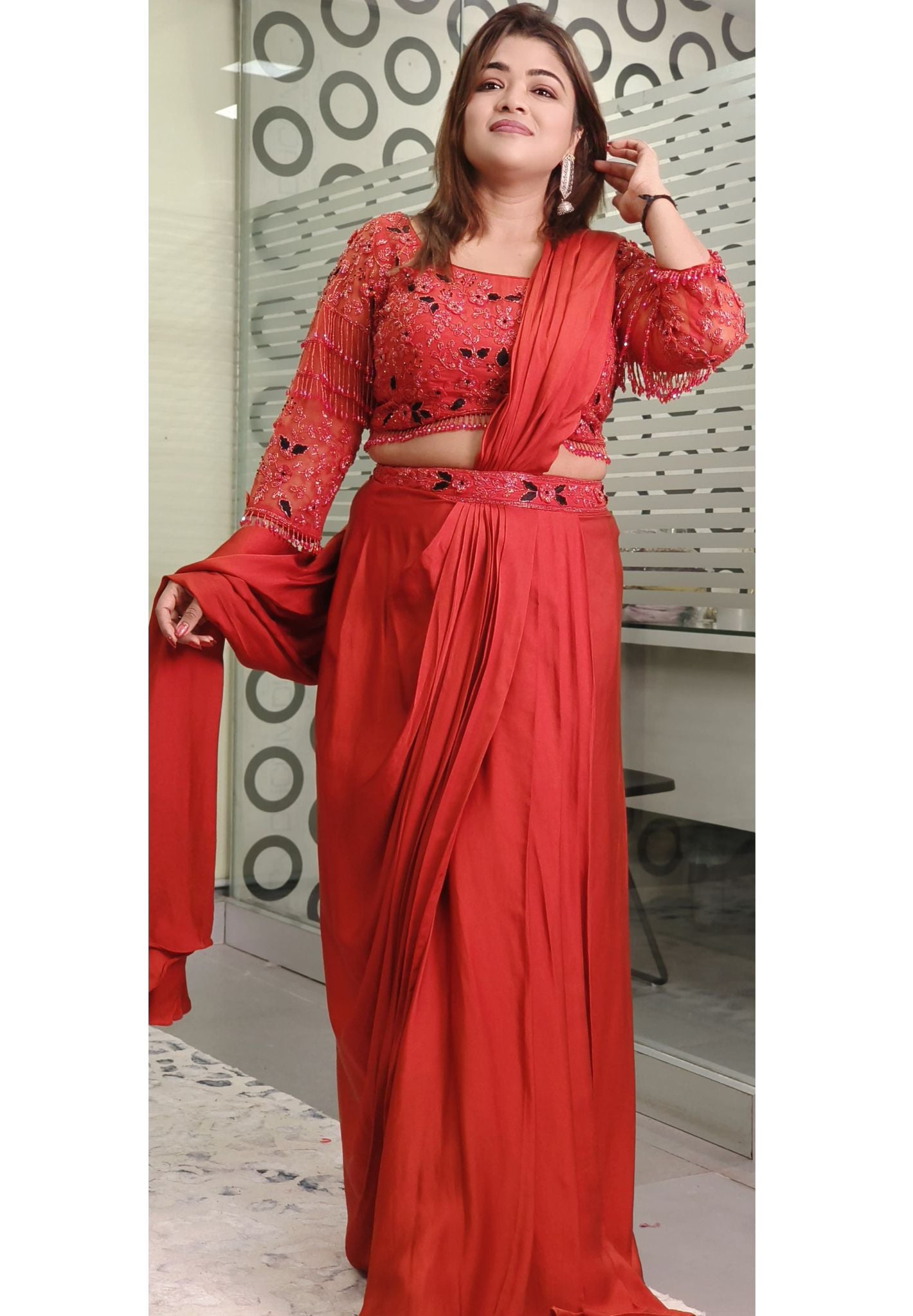 Rust Crystal-Embellished Crepe Dhoti Saree Set A designer ensemble featuring a heavily adorned crystal work blouse paired with a trendy drape dhoti-style saree DRY WASH-ONLY ON ORDERS DISPATCHING AFTER 30 DAYS -