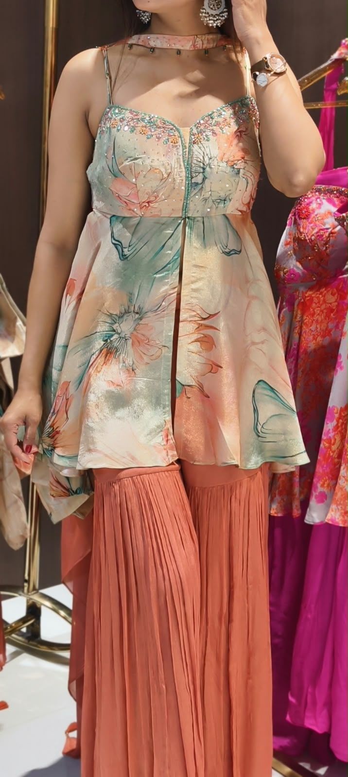 Soft Peach & Coral Floral Printed Noodle Strap Peplum Tunic Set with Pleated Sharara & Beaded Chowker Dupatta- 12759