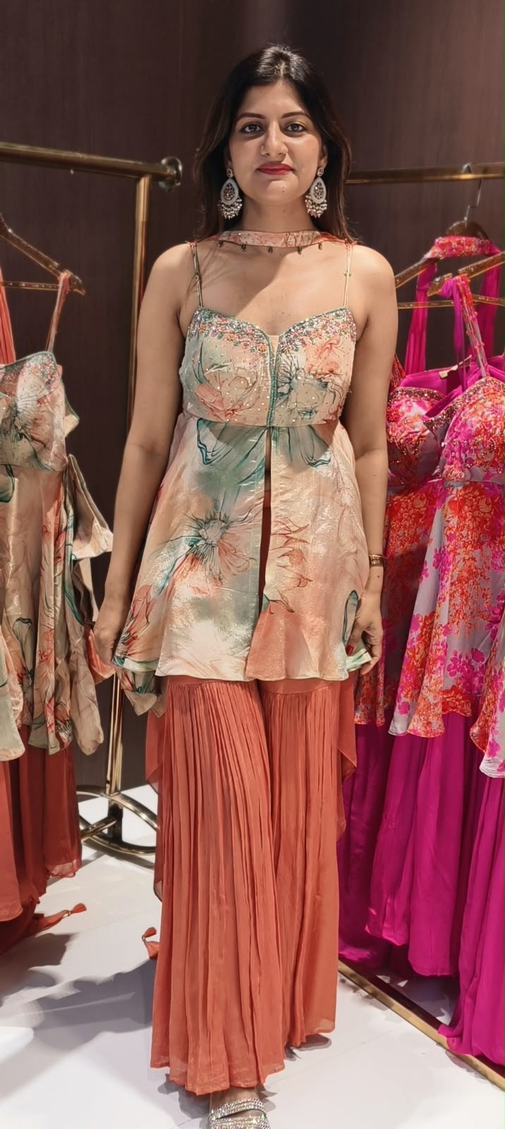 Soft Peach & Coral Floral Printed Noodle Strap Peplum Tunic Set with Pleated Sharara & Beaded Chowker Dupatta- 12759