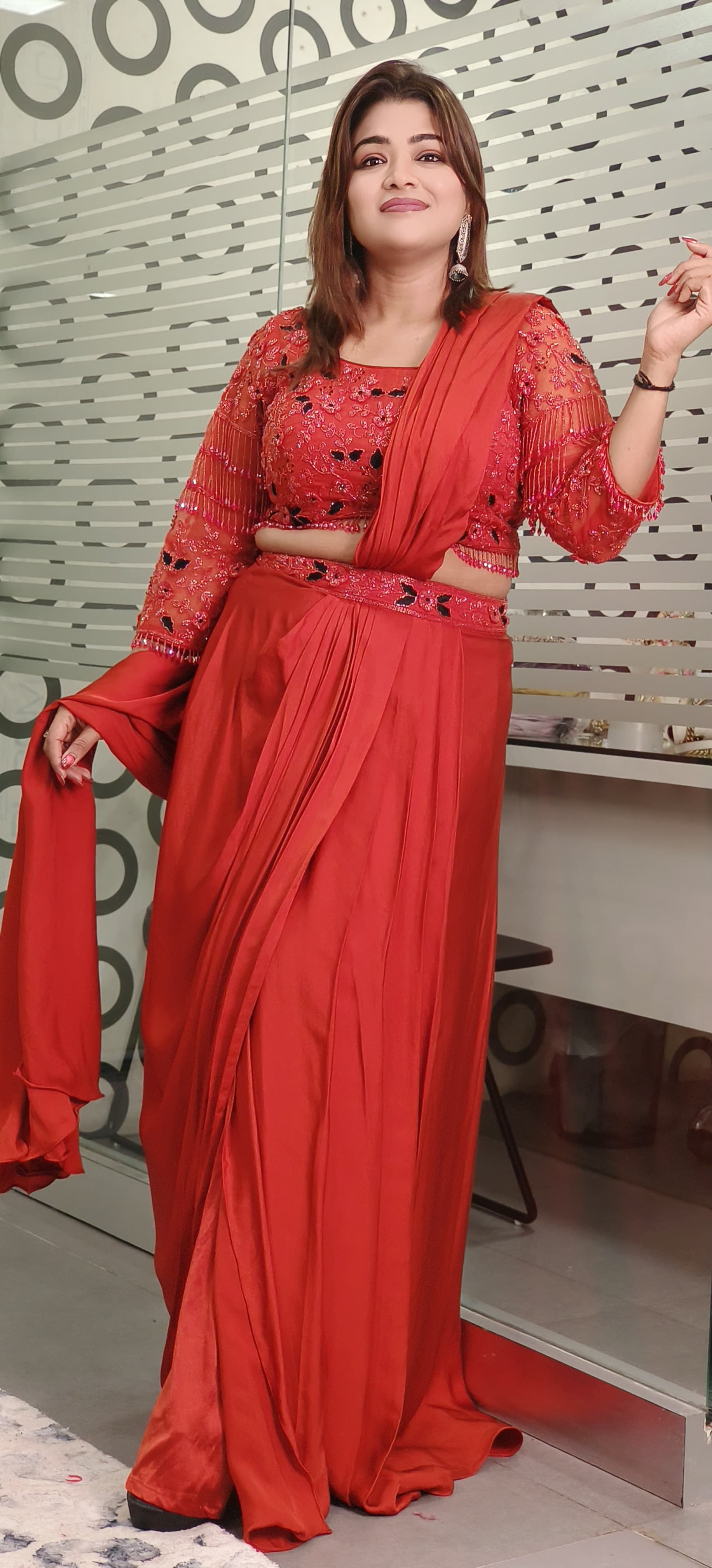 Rust Crystal-Embellished Crepe Dhoti Saree Set A designer ensemble featuring a heavily adorned crystal work blouse paired with a trendy drape dhoti-style saree DRY WASH-ONLY ON ORDERS DISPATCHING AFTER 30 DAYS -