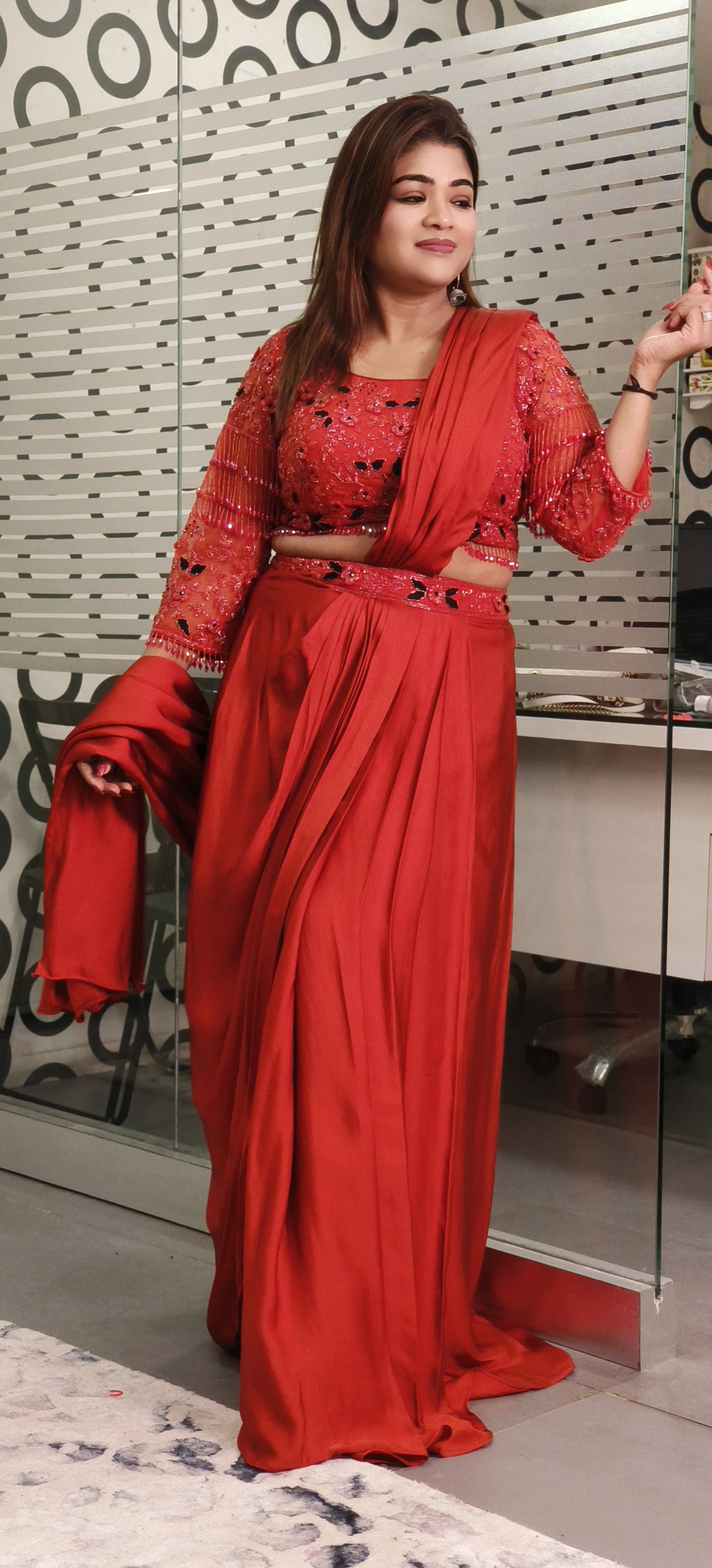 Rust Crystal-Embellished Crepe Dhoti Saree Set A designer ensemble featuring a heavily adorned crystal work blouse paired with a trendy drape dhoti-style saree RB89