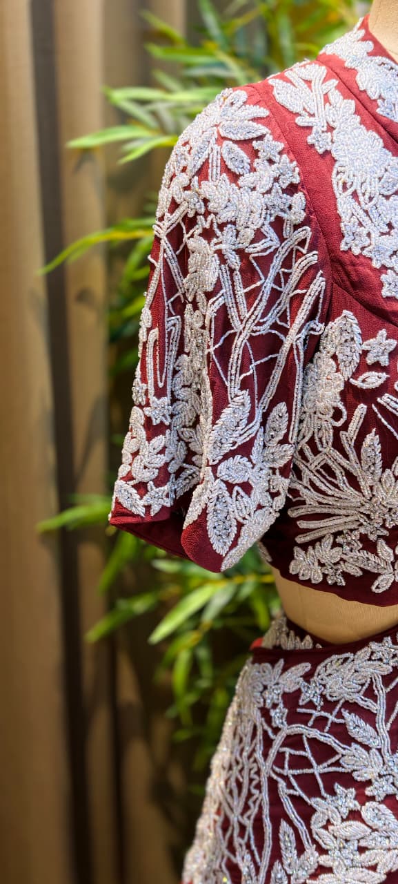 Deep Wine Georgette Multi-Tiered Ruffle Lehenga with Heavily Embroidered Silver Zardoz Asymmetric Overlap Blouse and Attach-Style Dupatta
