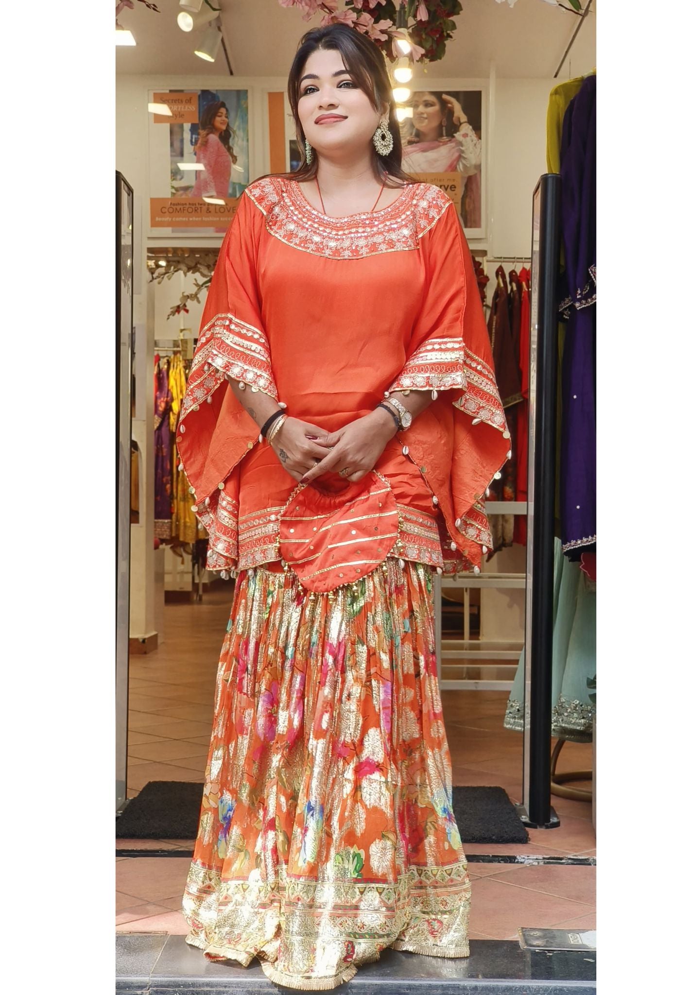 Embellished short Kaftan Top with Floral Print shimmer Sharara Set - Embroidered Neckline and Hem Detail, Mustard Base with Multi-Color Floral Pattern Bottom With Potali bag DRYWASH