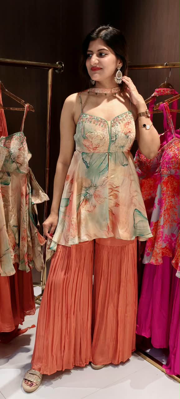 Soft Peach & Coral Floral Printed Noodle Strap Peplum Tunic Set with Pleated Sharara & Beaded Chowker Dupatta- 12759