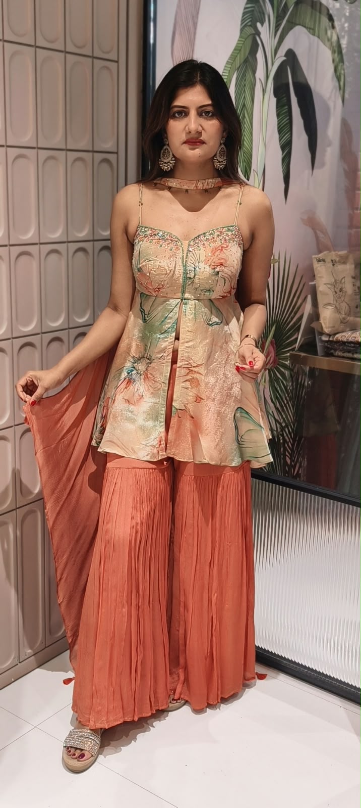 Soft Peach & Coral Floral Printed Noodle Strap Peplum Tunic Set with Pleated Sharara & Beaded Chowker Dupatta- 12759