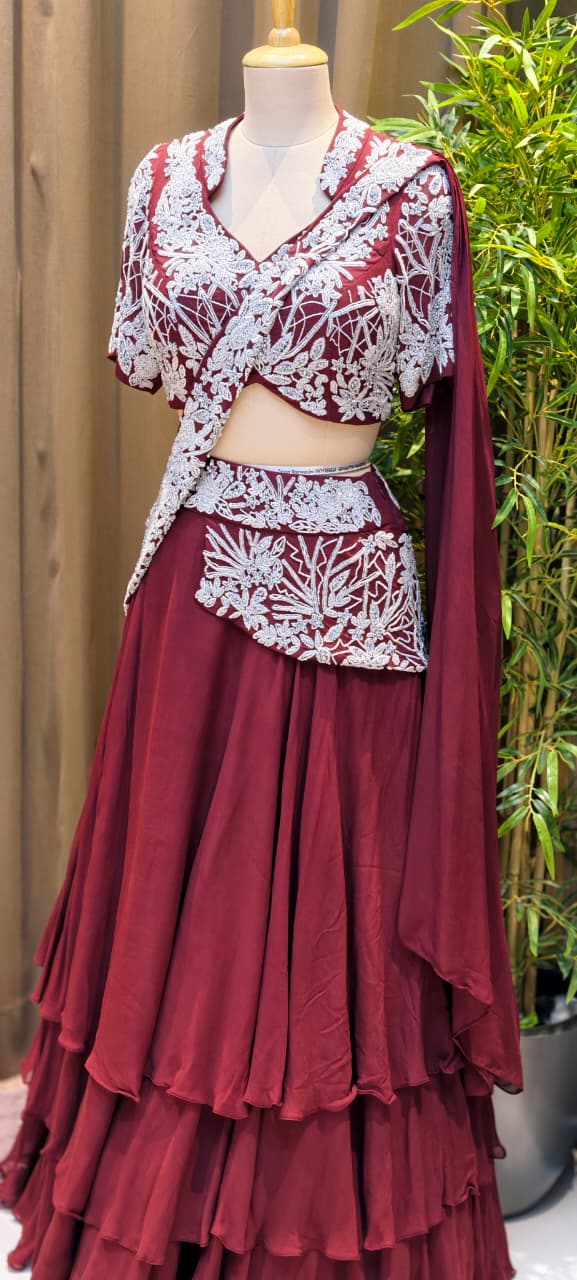 Deep Wine Georgette Multi-Tiered Ruffle Lehenga with Heavily Embroidered Silver Zardoz Asymmetric Overlap Blouse and Attach-Style Dupatta